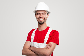Friendly smiling builder in uniform looking at camera