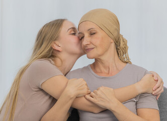 A young and beautiful daughter kiss her mother cancer patient and fortifies her to fight during the...