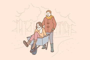 Entertainment for romantic couple concept. Man cartoon character boyfriend or husband cartoon character carrying riding woman In wheelbarrow collecting autumn leaves from garden together illustration