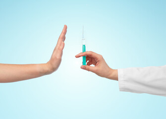 medicine, vaccination and healthcare concept - hand of doctor with syringe and patient showing stop...
