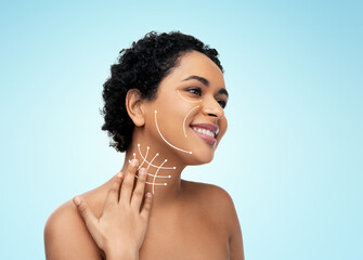 beauty, plastic surgery and people concept - happy smiling young african american woman with arrows...