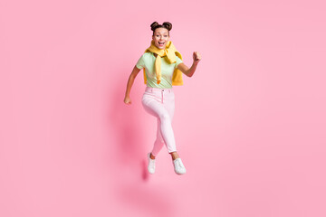 Fototapeta na wymiar Full body photo of cheerful charming young woman jump up run sale isolated on pastel pink color background