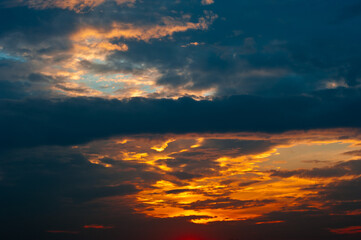 Beautiful summer sunset sky, yellow clouds