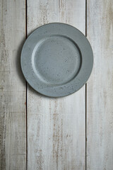 gray plate on wooden table