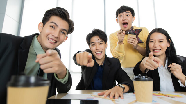 A group of multi-sex colleagues businesspeople working together in teleconference online zoom meeting, looking to webcam camera with cheerful and excited for good news and success with the team