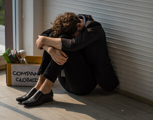 financial depression, unemployment, bankruptcy concept. Unhappy Caucasian businessman sitting and...