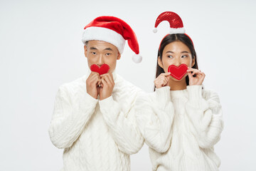 Christmas New Year asians man and woman with hearts in their hands