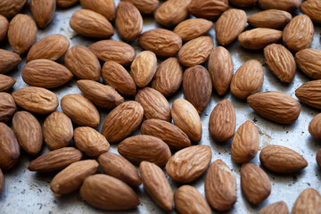 roasted almonds are on a baking sheet. Homemade almonds, protein, healthy nuts. Almond kernels