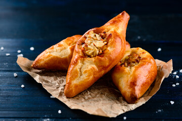 russian pie rasstegay with a hole on top, Traditional Russian, Slavic pies with hole in center. Rasstegay on wooden background