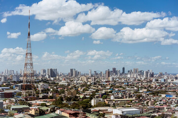 Quezon City, Philippines - A tall transmission tower and the Metro Manila skyline.