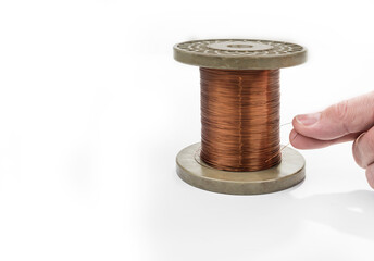 Copper wire on a reel on a white background