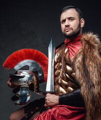 Studio shot of roman officer with sword and helmet