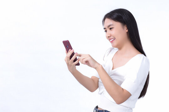 Portrait of asian beautiful woman Use the mobile phone happily on a white background.