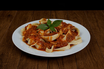 Pasta Tagliatelle with bolognese sauce and basil leaves. Pasta and pasta. Photography with food in the center.