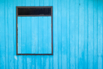 Obraz na płótnie Canvas Blue wooden window on Blue wall
