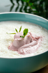 Bowl of fresh curd with mousse on the decorated background