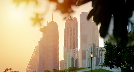 Colorful Skyline of Qatar City during sunset. with leaves in the frame.