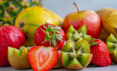 Mix of fruits on top of a wooden piece.