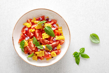 Tomato and corn salad with fresh basil and red onion