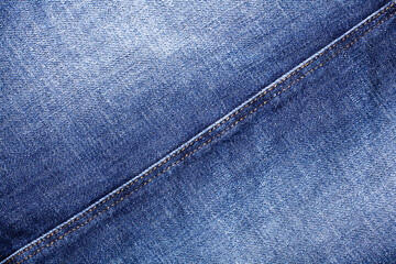 Blue jeans texture, diagonal seam closeup, thread stitch line, jean textile background, blue denim...