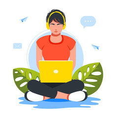 Business woman sitting in lotus position on floor using laptop and headphones.girl wearing headphones working at home on a laptop in lotus position. Freelance, online studying, work from home concept
