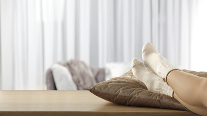Woman legs on table and home interior. 