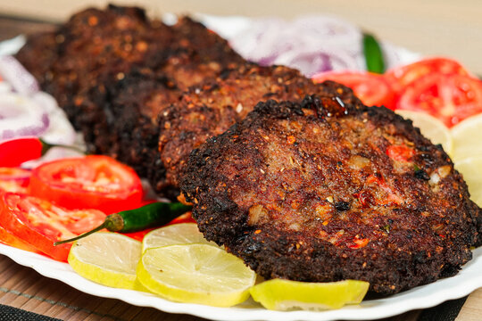 chapli kabab desi Pakistani food display in a plate
