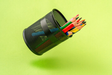 Colored pencils in a black mesh pen pot