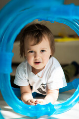funny boy playing at home, 2 years old, at home, selective focus
