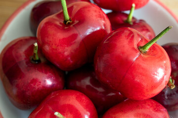 Fresh cherries over a wooden surface