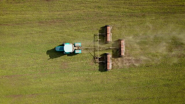 Top down view natural eko fertilizer with manure. Farmer on powerful tractor fertilizing arable soil. Manure intended for increase in productivity. Concept of work in agricultural farm for making