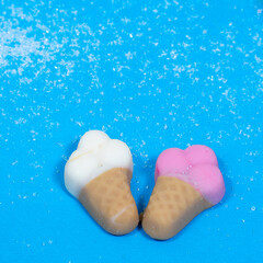 jelly marmalade ice cream cone on blue background with copy space