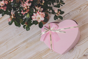 Cute gift with love for mom. Surprise. Pink heart-shaped box and beautiful flowers. Happy everyday