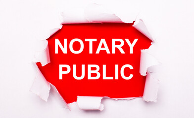Torn white paper lies on a red background. On red, the text is white NOTARY PUBLIC