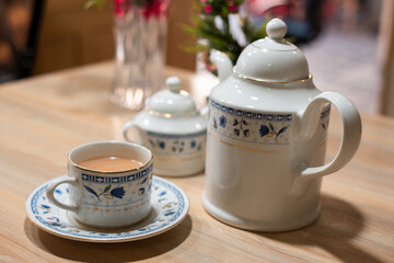 white floral tea set on a table with tea