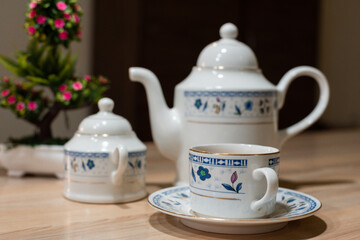 white floral tea set on a table with tea