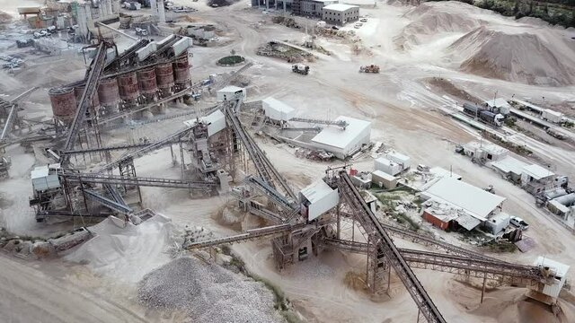 Quarry with Stone sorting conveyor belts and an open pit mine. 