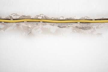 Hidden installation of electrical wires in a old plastering wall. Repair in an old apartment and...