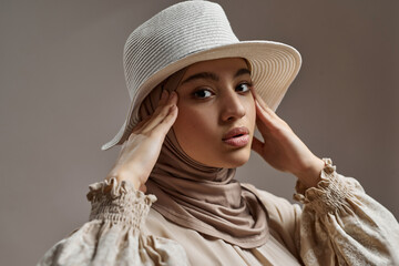 Portrait of modern arabian woman in hijab and hat