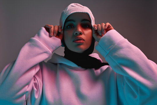 Young arabian girl in hijab, panama hat and hoodie