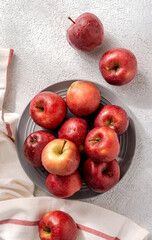 Ripe red apples on grey plate. Top view with space for your text.