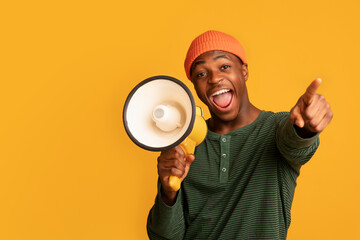 Cheerful Black Guy Shouting In Loudspeaker And Pointing At Camera