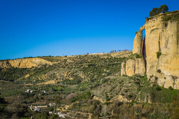 Fototapeta na wymiar View on the cliffs from the foot of the Ronda bridge in Andalusia, Spain