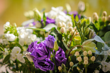 Purple roses in flower arrangement. Close up.