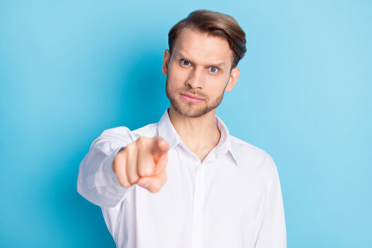 Portrait of attractive suspicious man ceo boss chief pointing at you come here isolated over bright blue color background