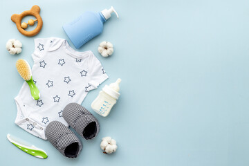 Kids toys and items. Flat lay of bodysuit with accessories for baby boy