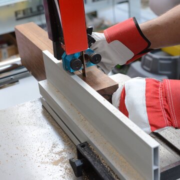 Cutting of ovangkol wooden plate on band saw. Guitar making
