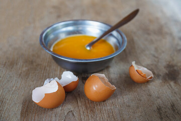 Raw eggs stirred in a bowl for cooking