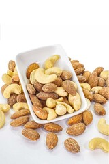 Assorted beans in a cup and on a white background