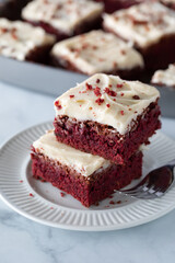 A small stack of red velvet chocolate brownie squares ready for eating. 